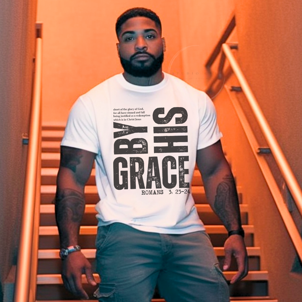 Man wearing a white t-shirt with 'GRACE' printed on it, standing on stairs with an orange hue.