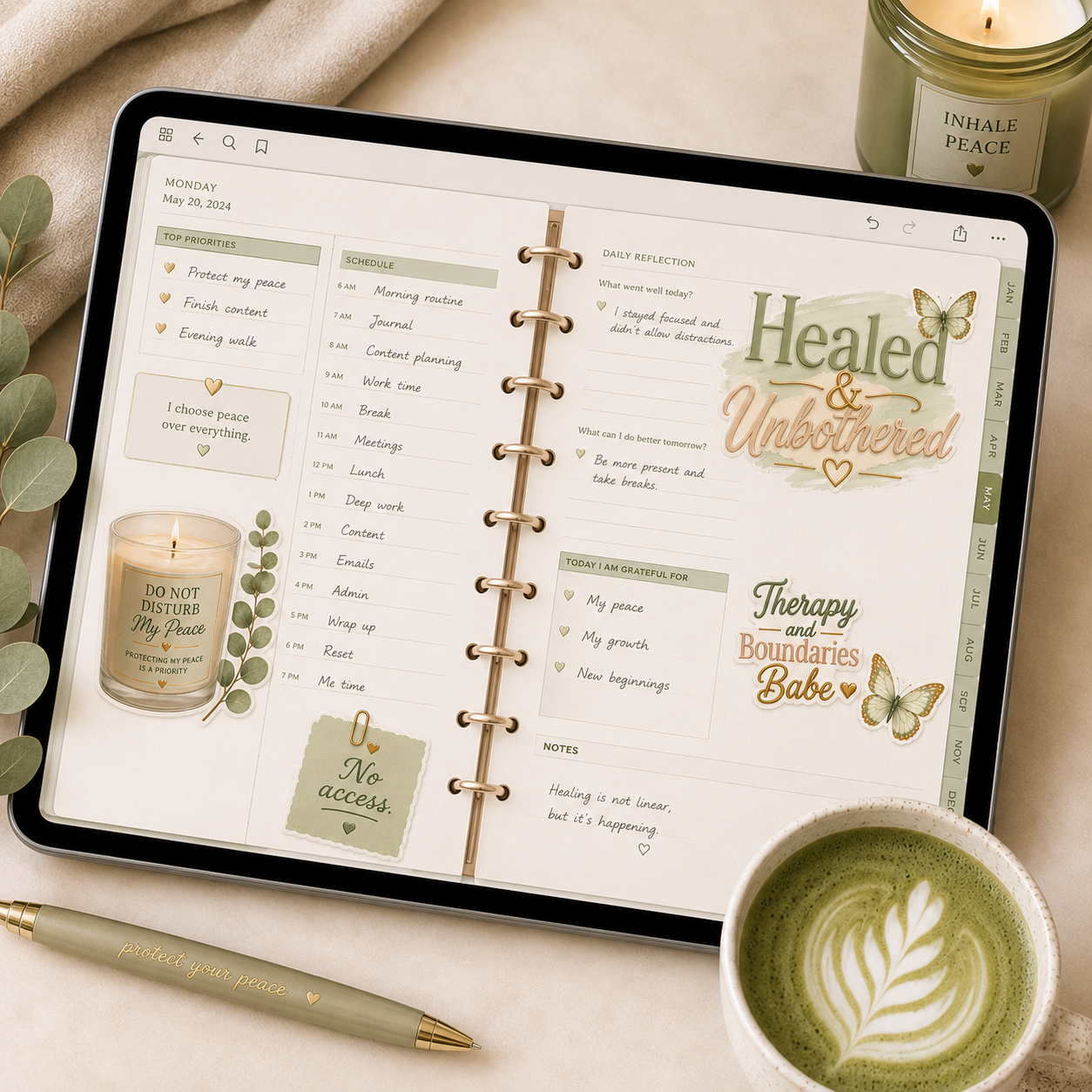 Digital planner on a tablet with a cup of coffee, pen, and candle on a table.